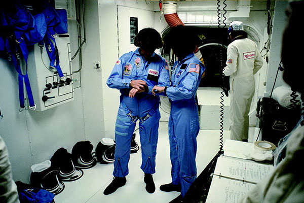 Kathryn Sullivan (left) and Sally Ride (right) pretend to synchronize
their watches while waiting to board the space shuttle Challenger
on October 5, 1984.