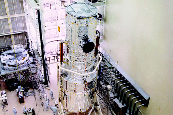 The Hubble Space Telescope in the VATA clean room. Note the people
at lower left for scale.