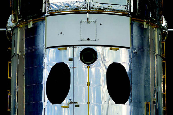 Lower, “aft shroud” section of Hubble, showing the three star-tracker
ports (two black ovals and black circle just below the white panel of the
Wide Field/Planetary Camera).